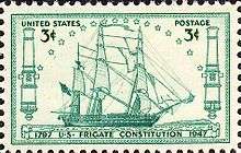 A postage stamp depicts Constitution at sail. The ship sails to the right side of the stamp.