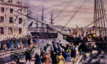 Two ships in a harbor, one in the distance. On board, men stripped to the waist and wearing feathers in their hair throw crates of tea overboard. A large crowd, mostly men, stands on the dock, waving hats and cheering. A few people wave their hats from windows in a nearby building.