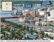 Flood water of Cedar River is over several main street bridges and up to the windows of several public buildings such as the courthouse and city hall.