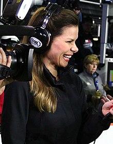 Dressed in a black shirt, wearing a Fox Sports headset