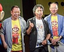 An image of the three integral staff who worked on the game: director Takashi Tezuka, producer Shigeru Miyamoto, and composer Koji Kondo.