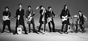 A promotional photo from Hard Disk (2013) featuring all seven members of the band: (from left) HZM, Ukigumo, Seiji Kameda, Ringo Sheena, Ichiyo Izawa, Mikio Hirama and Toshiki Hata.