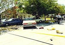 Crime scene photo of the FBI Miami shootout, showing suspect and agents' vehicles and battle debris. Photo by Miami-Dade PD.jpg