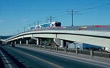 A MAX train traveling across a long viaduct