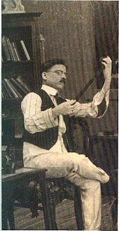 A black-and-white picture of a man looking at the filmstrip