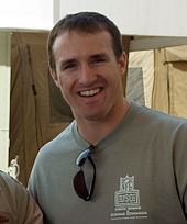 A light-skinned man wearing a green shirt