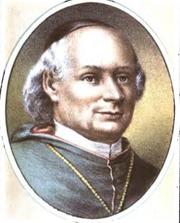 Portrait of a clean-shaven man wearing a cassock and a skullcap on his head.