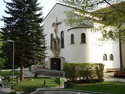 Main portal of the Roman Catholic Heart of Jesus Peace Church in Eichgraben named "Duomo of Vienna Woods" with crucifixion ensemble from sandstone of Adolf Treberer-Treberspurg
