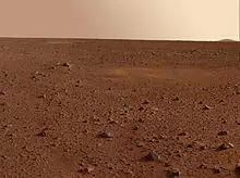 view of Martian desert showing rock field to the horizon