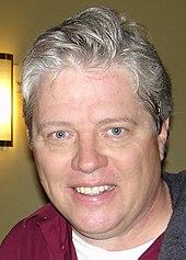 A left-profile picture of actor Thomas F. Wilson smiling
