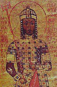 A bearded man wearing a crown