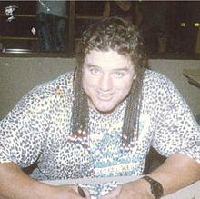 Smith seated, smiling
