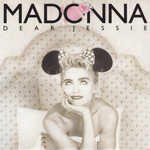 Sepia-toned image of Madonna sitting on a bed, holding the bedsheet to her bosom. She wears a Minnie Mouse headdress with a large bow. Madonna looks upwards where the word "Madonna" has been printed in uppercase letters. A hand-drawn pink elephant is squeezed inside the letter O, beneath which "Dear Jessie" has been printed (also in uppercase) with spaces between each of the letters.