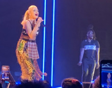A color photograph of Gwen Stefani performing live.