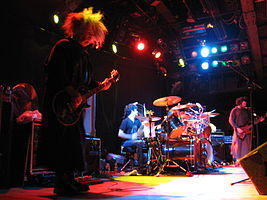 Melvins live in October 2006. Left to right: Buzz Osborne, Coady Willis, Dale Crover (behind drum kit) and Jared Warren.
