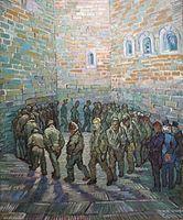 In an indoor prison yard a large group of men walk in a circle, one behind the other. The face of the prisoner in the centre of the painting and looking toward the viewer looks like Van Gogh.
