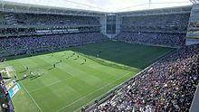 Stadium interior with supporters, photographed from one of its corners