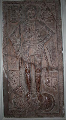 An armed knight standing on a lion, surrounded by four coat-of-arms