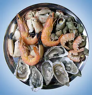 A seafood platter composed of shrimp, oyster, snail and crab.