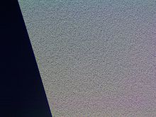 This is a photomicrograph of the pits at the inner edge of a CD-ROM; 2 second exposure under visible fluorescent light.