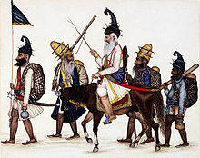 5 early Akali Sikh warriors, one carrying a flag, one on horseback.