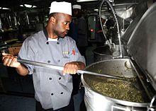 US Navy 081127-N-7571S-011 Culinary Specialist Seaman Freddie Green prepares collard greens for the crew's Thanksgiving dinner.jpg