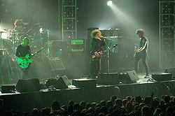 The Cure performing in August 2007. From left to right: Pearl Thompson, Jason Cooper, Robert Smith, and Simon Gallup