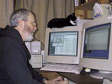 Tim Scully and his cat Merlin, writing software for Autodesk, December 24, 2000.jpg