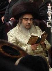 Grand Rabbi Aaron Teitelbaum, Satmar Rebbe, in synagogue, on Hanukkah, in Kiryas Joel, New York State.jpg