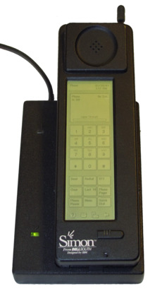 Photograph of the Simon Personal Communicator shown in its charging base