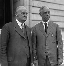 Two men in suits outside.
