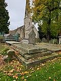 Photograph of the grave of Louisa Cooke, née Hardy, with St Peter's Church, Leckhampton, shown in the background.