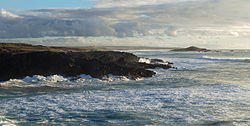 The island of Pessegueiro as seen from the village of Porto Covo, during a winter storm