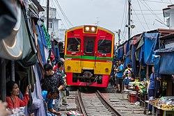 Maeklong Railway Market, also known as Talat Rom Hup when the train arrives