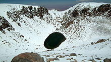 Aerial view of Licancabur Lake, surrounded by snow