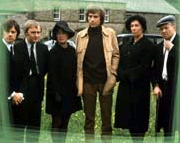 Six adults outdoors, in funeral clothing
