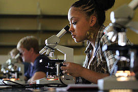 Southern Arkansas University Biology student with microscope.jpg