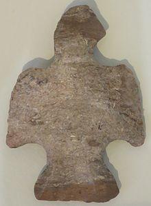 Flaked, banded light brown stone, shaped like a displayed bird.