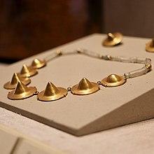 Tairona gold earrings and necklace from AD. 1000. Shaped like cymbals.