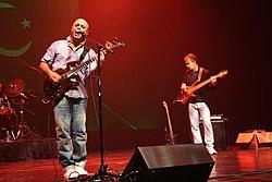 Junoon performing live at a concert. Visible from left to right are; Ali Azmat and Brian O'Connell.