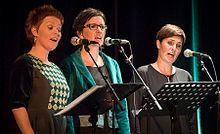 The trio at stage at a concert in 2016