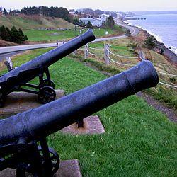 The island community of Arichat, Isle Madame, Nova Scotia as seen from Cannon Look-Off. These cannons commemorate the eighteenth century period of the community's long history.