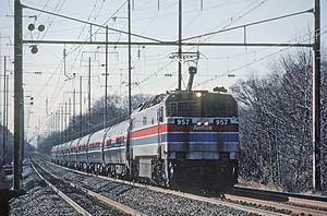Locomotive with a raised pantograph and nine cars trailing
