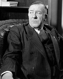 Black-and-White image of Raymond Springer wearing a suit.