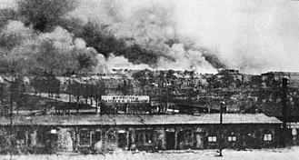 Warsaw-Gdansk railway station with Warsaw Ghetto burning, 1943.jpg