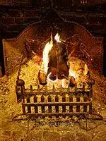 Open fire in hearth grate at The Black Horse Inn, Nuthurst, West Sussex.jpg