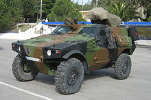 Front view of a VBL with a French-style camouflage. The older Greek flag is painted on its license plate.