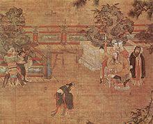 A painting of a play being staged in a courtyard. In the centre, a man in loose black robes appears in mid-bow or mid-dance. To the left, two men dressed as guards are holding a third man, dressed in the same attire as the man in the centre. To the right, a heavy set man sits in a throne. Behind him stand three women in white face paint and a man dressed in the same attire as the man in the center.
