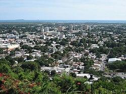 Partial view of the city of Ponce in 2006, as seen from Cerro del Vigía, with the Caribbean Sea and Caja de Muertos in the background