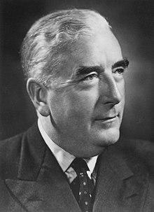 Menzies was thickset elderly Anglo-Saxon man, cleanshaven and wearing a suit.
